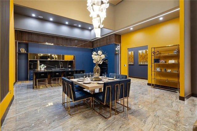 4704 Estancia Pkwy, Mcallen, TX 78504 - dining space with a towering ceiling, light marble finish floors, baseboards, a chandelier, and recessed lighting