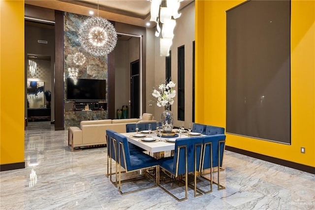 4704 Estancia Pkwy, Mcallen, TX 78504 - dining room featuring a chandelier, marble tiled flooring, and baseboards