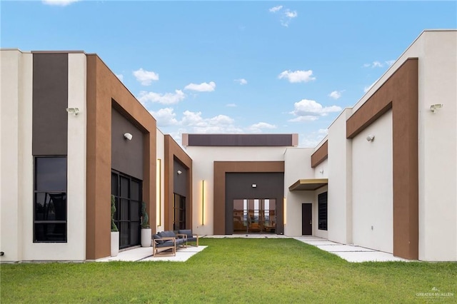 4704 Estancia Pkwy, Mcallen, TX 78504 - back of house with stucco siding and a lawn