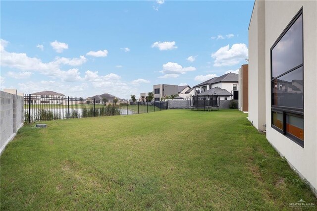 4704 Estancia Pkwy, Mcallen, TX 78504 - view of yard featuring a trampoline, a residential view, and a water view