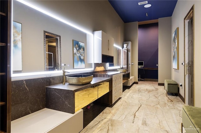 4704 Estancia Pkwy, Mcallen, TX 78504 - kitchen featuring light marble finish flooring, a sink, and white cabinets