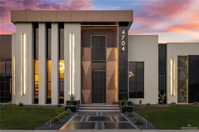 4704 Estancia Pkwy, Mcallen, TX 78504 - exterior entry at dusk with stucco siding and a yard