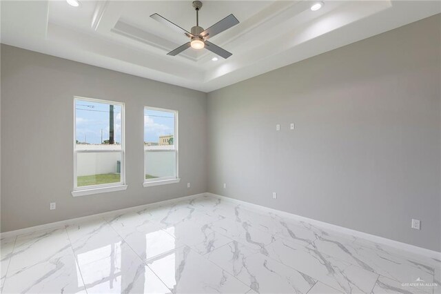 3205 Brentwood St, Edinburg, TX 78539 - spare room featuring a raised ceiling, a ceiling fan, baseboards, marble finish flooring, and recessed lighting