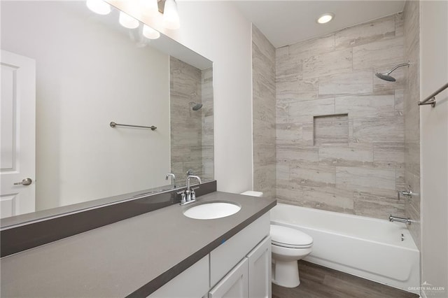full bath featuring vanity, shower / bathtub combination, toilet, recessed lighting, and wood finished floors