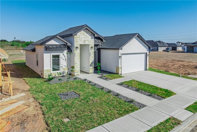 view of front of house featuring a garage, driveway, stone siding, stucco siding, and a front yard