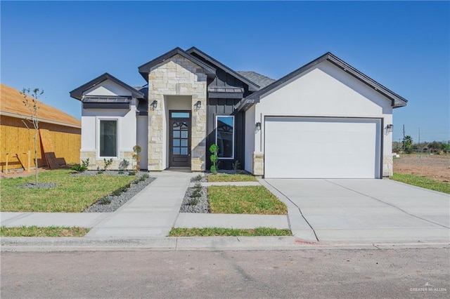 view of front of home with concrete driveway, stone siding, an attached garage, a front lawn, and stucco siding