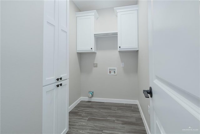 washroom with washer hookup, cabinet space, dark wood finished floors, and baseboards