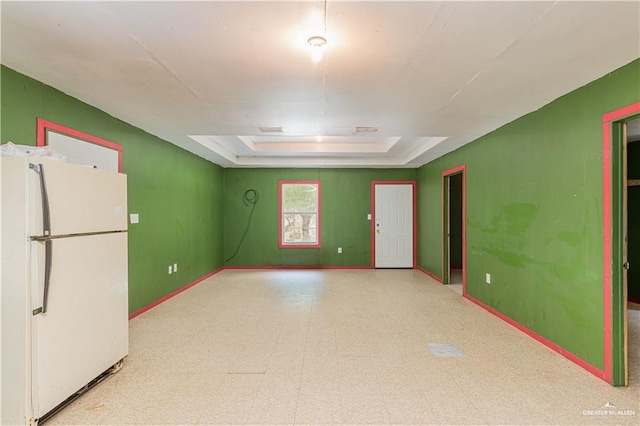 spare room featuring a raised ceiling