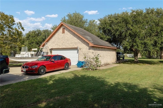 view of side of property with a garage and a lawn