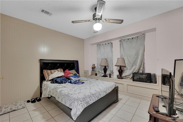 tiled bedroom with ceiling fan