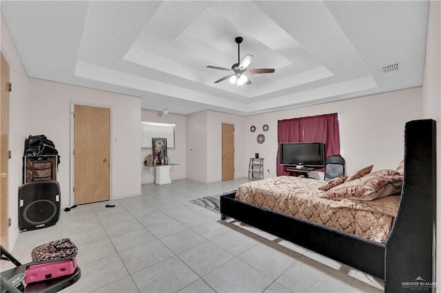 bedroom featuring a tray ceiling and ceiling fan