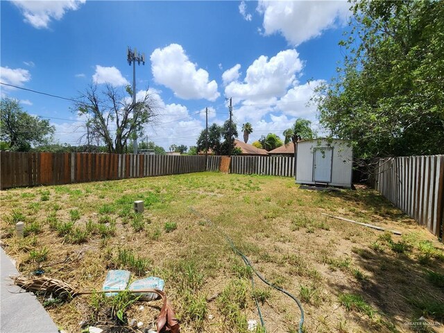 607 N Padre Ave, Weslaco, TX 78596 - fenced backyard with a shed