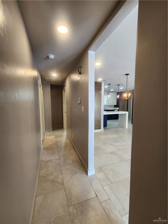607 N Padre Ave, Weslaco, TX 78596 - hall with baseboards and recessed lighting
