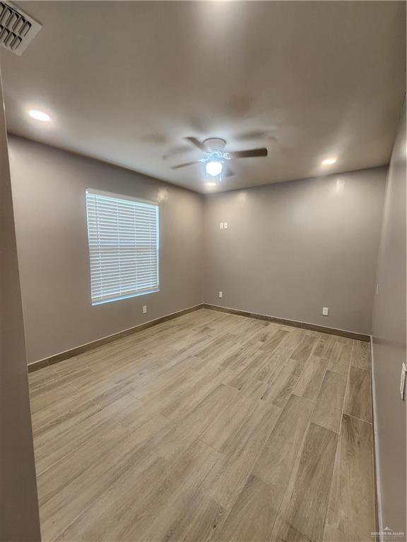 607 N Padre Ave, Weslaco, TX 78596 - spare room with a ceiling fan, light wood finished floors, and recessed lighting