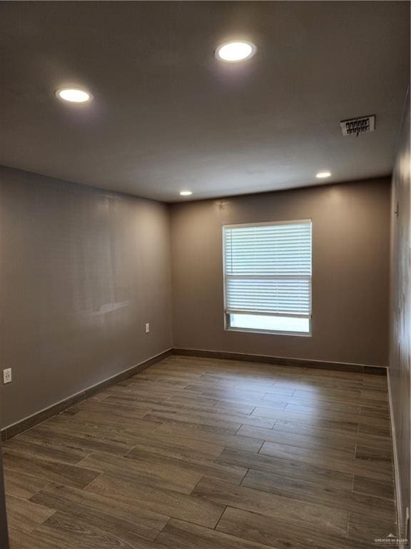 607 N Padre Ave, Weslaco, TX 78596 - empty room with dark wood finished floors and recessed lighting