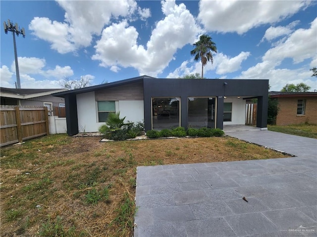 607 N Padre Ave, Weslaco, TX 78596 - view of front facade featuring stucco siding and a carport
