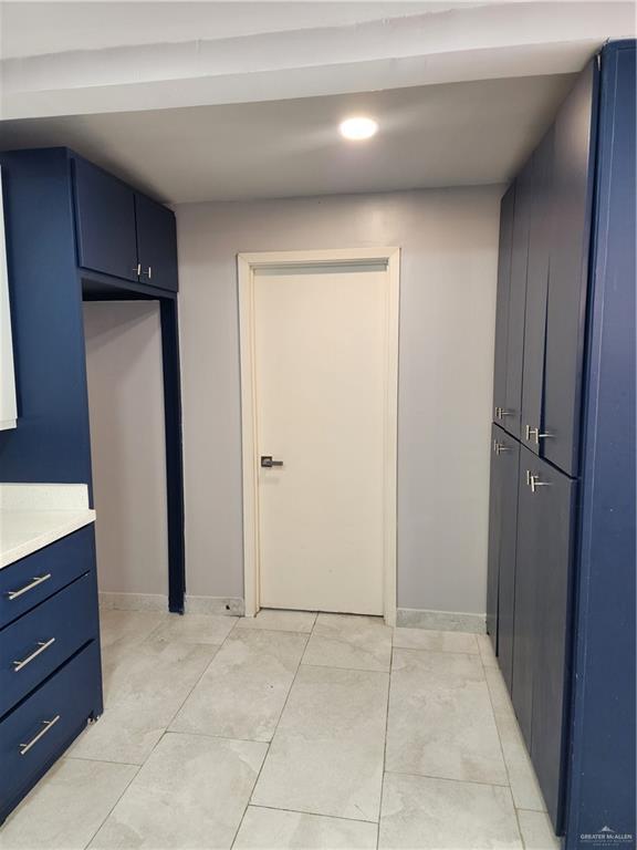 607 N Padre Ave, Weslaco, TX 78596 - kitchen with blue cabinets, light countertops, and recessed lighting
