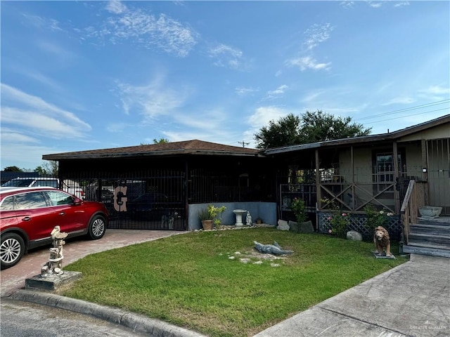 view of side of home with a yard and a carport