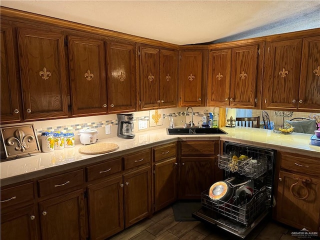 kitchen featuring decorative backsplash, sink, dishwasher, and dark hardwood / wood-style floors