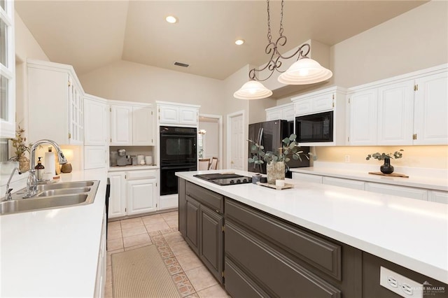 2009 E 29th St, Mission, TX 78574 - kitchen with a sink, black appliances, white cabinets, light countertops, and lofted ceiling