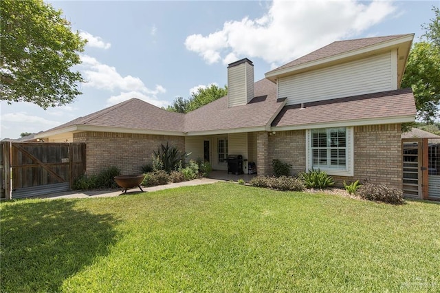 2009 E 29th St, Mission, TX 78574 - rear view of house with brick siding, a chimney, roof with shingles, and a gate