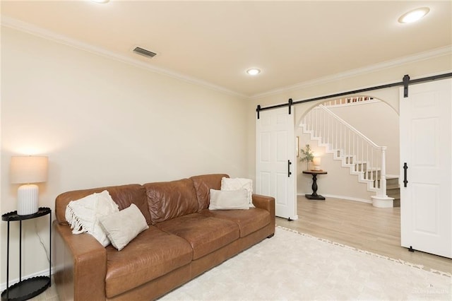 2009 E 29th St, Mission, TX 78574 - living area with a barn door, wood finished floors, crown molding, recessed lighting, and baseboards