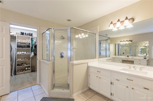 2009 E 29th St, Mission, TX 78574 - full bathroom with tile patterned floors, vanity, a stall shower, and a walk in closet