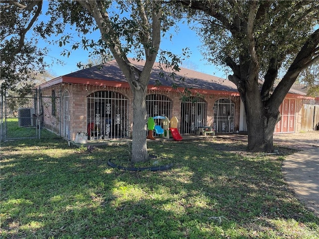 back of property with a lawn