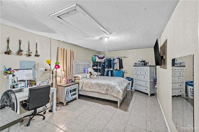 tiled bedroom featuring a textured ceiling