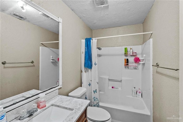 full bathroom with vanity, shower / bath combination with curtain, a textured ceiling, and toilet