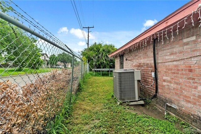 view of yard with a trampoline and cooling unit