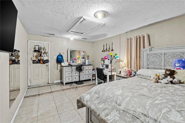 tiled bedroom featuring a textured ceiling and a closet