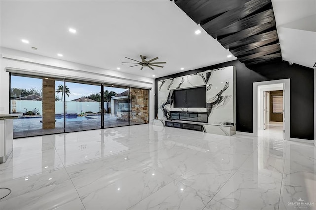 unfurnished living room featuring ceiling fan