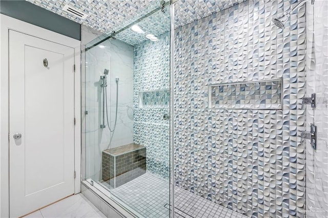 bathroom featuring a shower with door