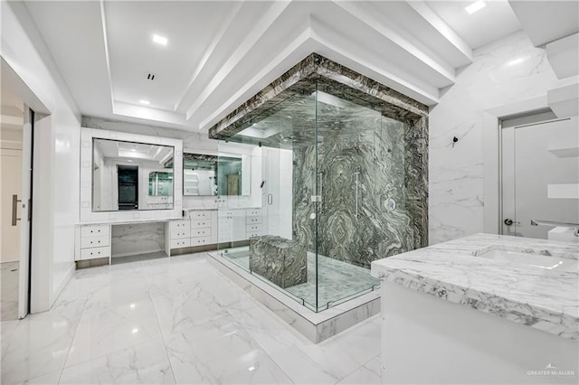 bathroom with a shower with door and vanity