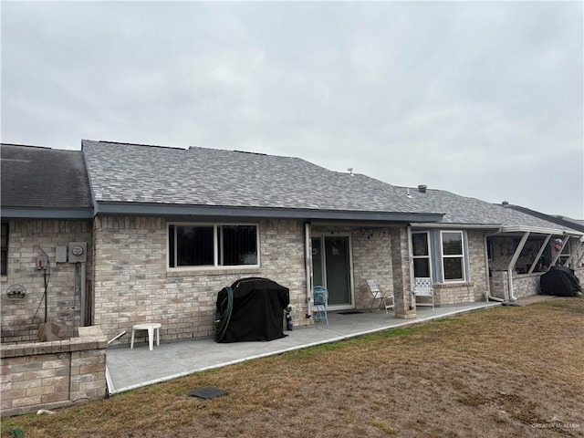 back of house with a yard and a patio area