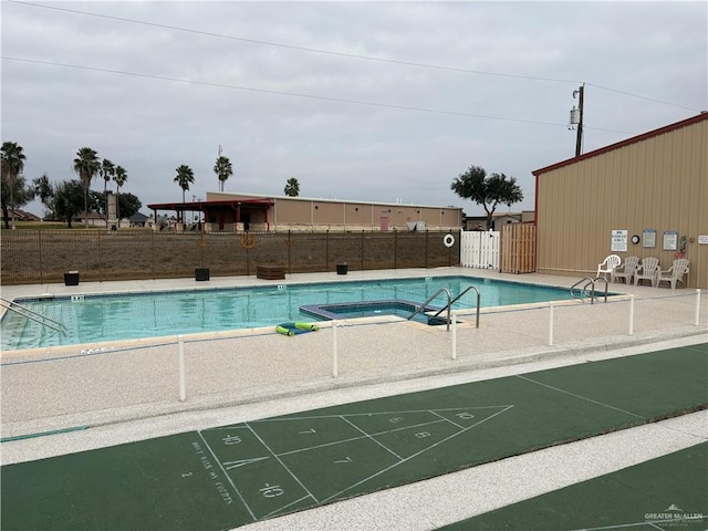 view of swimming pool featuring a community hot tub