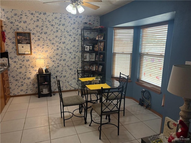 tiled dining room featuring ceiling fan, plenty of natural light, and a textured ceiling