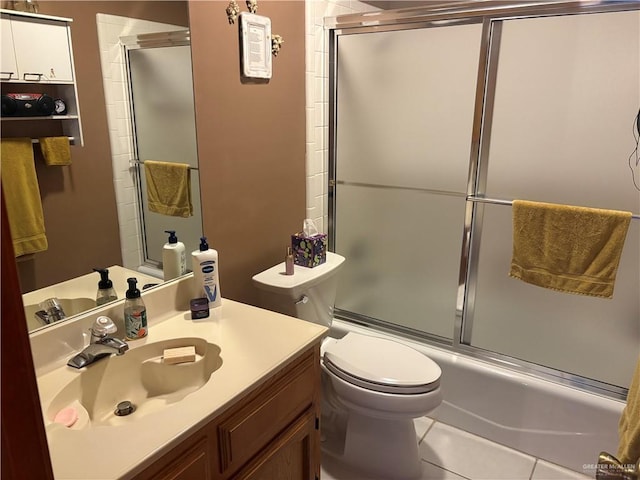 full bathroom with tile patterned flooring, vanity, toilet, and combined bath / shower with glass door