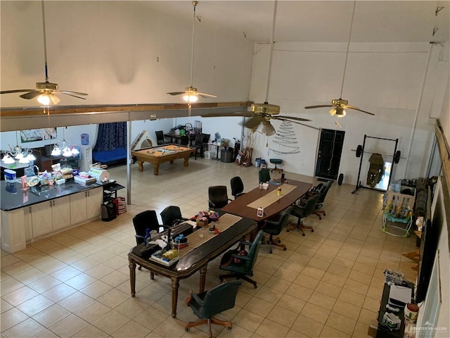 dining space featuring light tile patterned floors and high vaulted ceiling