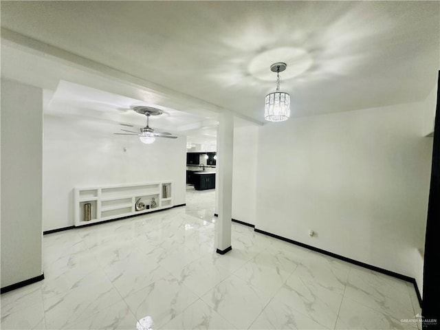 unfurnished living room with ceiling fan with notable chandelier