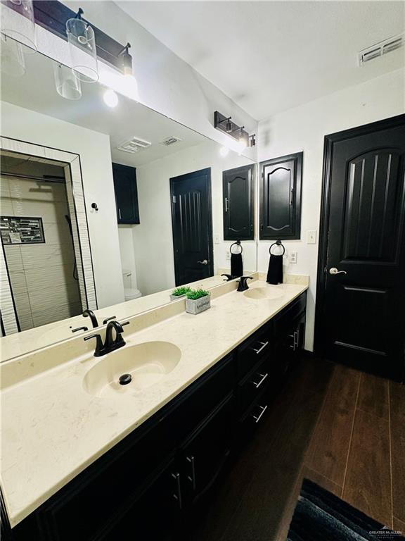 bathroom featuring vanity, hardwood / wood-style floors, and toilet