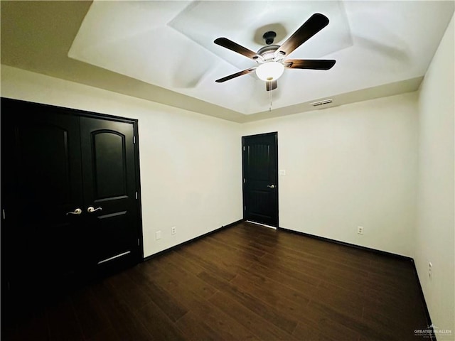 unfurnished bedroom featuring dark wood-type flooring and ceiling fan