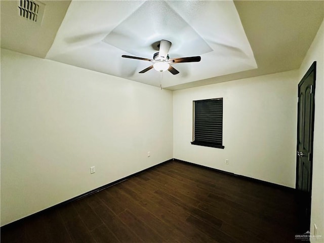 empty room with ceiling fan and dark hardwood / wood-style floors