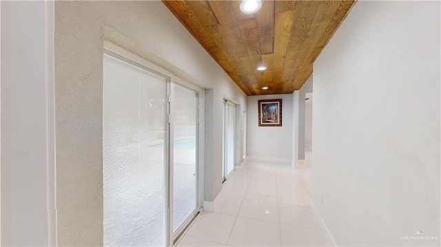 corridor featuring light tile patterned floors and wooden ceiling