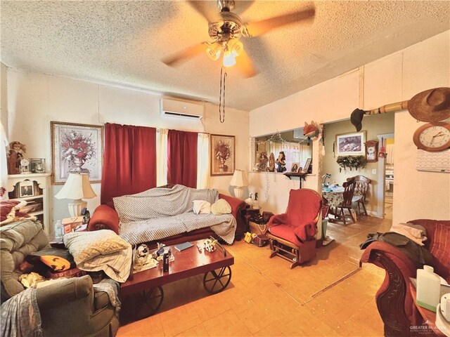 living room with a wall mounted air conditioner, a textured ceiling, and ceiling fan