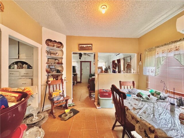 dining area with tile patterned flooring and a textured ceiling