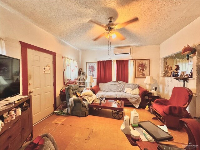 living room with a wall mounted air conditioner, a textured ceiling, and ceiling fan