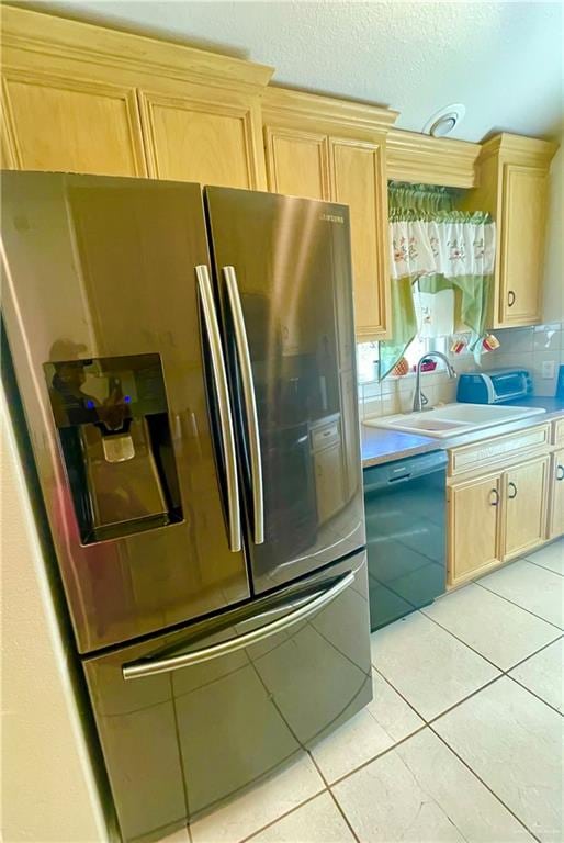 kitchen featuring stainless steel fridge, sink, black dishwasher, and light brown cabinets