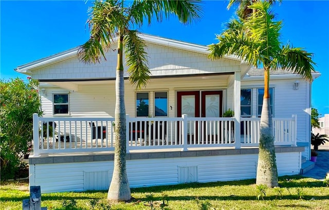 back of property featuring covered porch